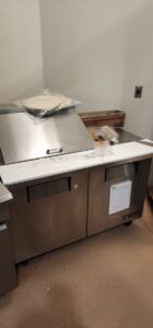 Installed cutting board and accessories onto prep table in north austin