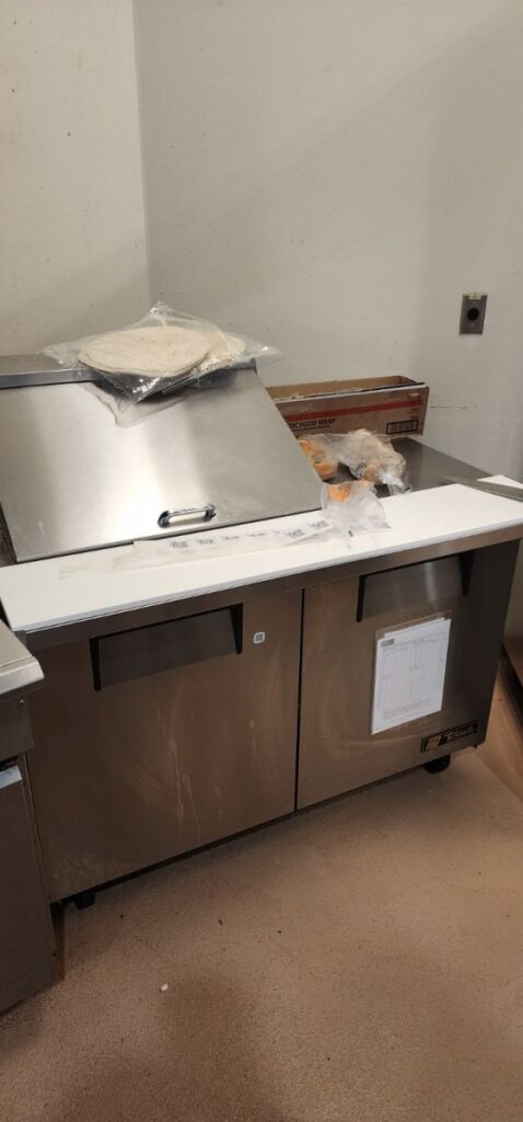 Installed cutting board and accessories onto prep table in north austin