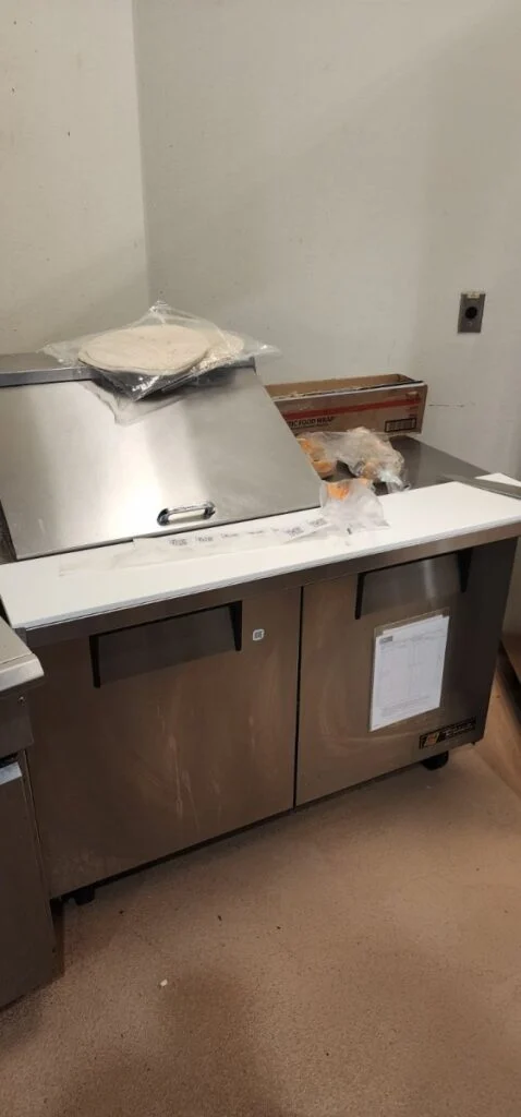Installed cutting board and accessories onto prep table in north austin