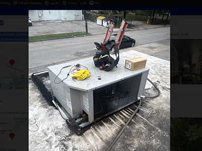Technician servicing rooftop commercial HVAC and refrigeration equipment during preventative maintenance in downtown Austin, TX