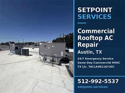 Commercial rooftop packaged HVAC units on a flat white roof at an Austin, TX distribution facility after AC repair